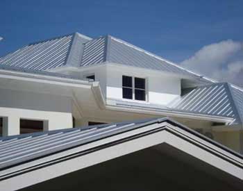 Close up of the front of a residential roof with a gray Cascadia metal roof system installed