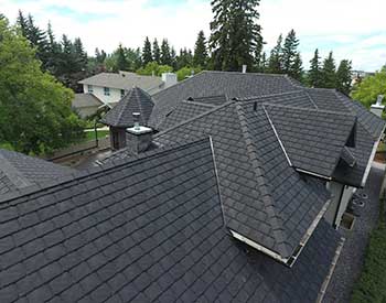 Close up of a residential roof with new gray Euroshield Rundle Slate tiles