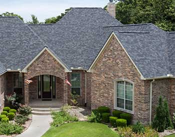 Front of a home with gray Malarkey asphalt shingles on its roof