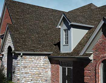 Front of a home with brown Owens Corning asphalt shingles on its roof