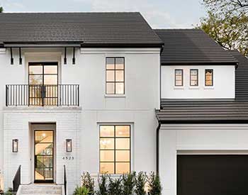 Front view of a home with a very dark gray metal roof by Vicwest